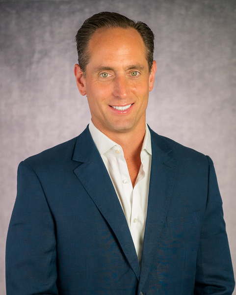 Picture of Mark in blue suit on grey background